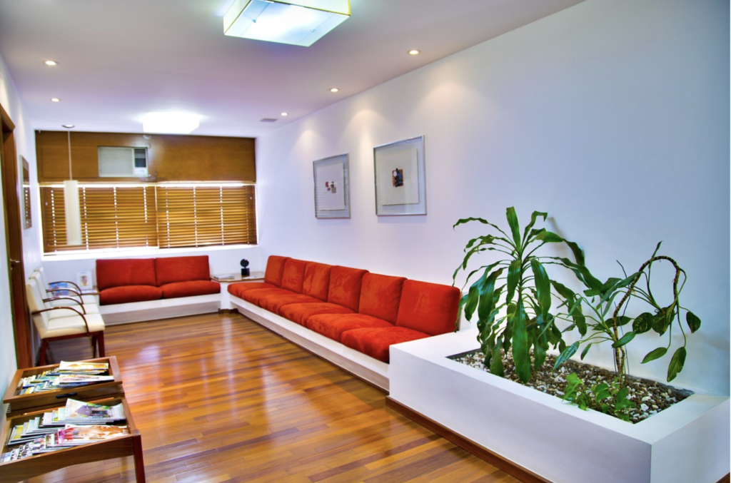 Modern luxury infusion waiting room with couches and plants.