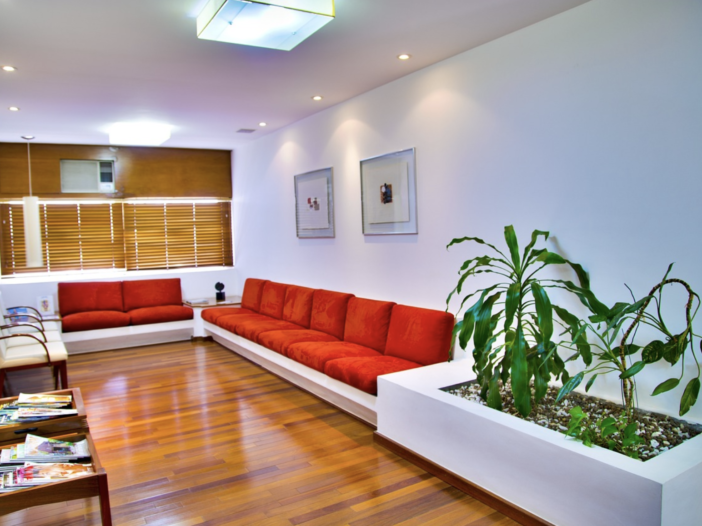 Modern luxury infusion waiting room with couches and plants.